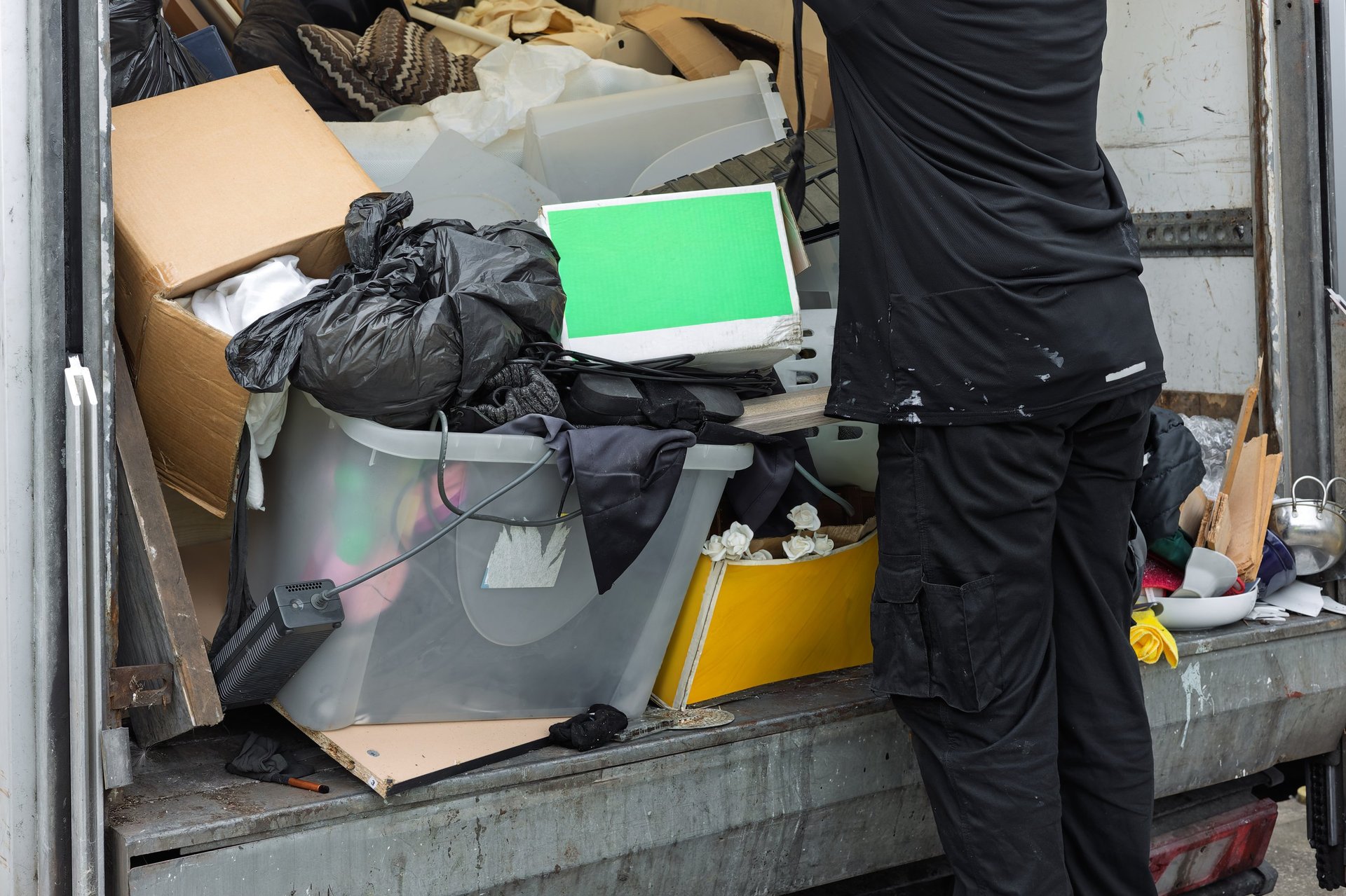 Junk removal professional loading items onto truck